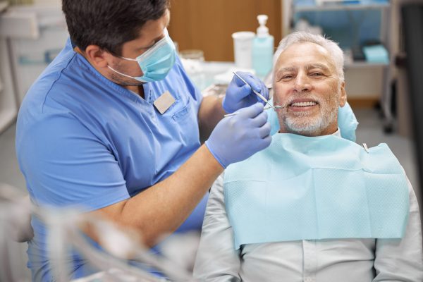 senior-patient-having-a-dental-treatment-at-the-cl-2023-11-27-05-37-14-utc-scaled.jpg